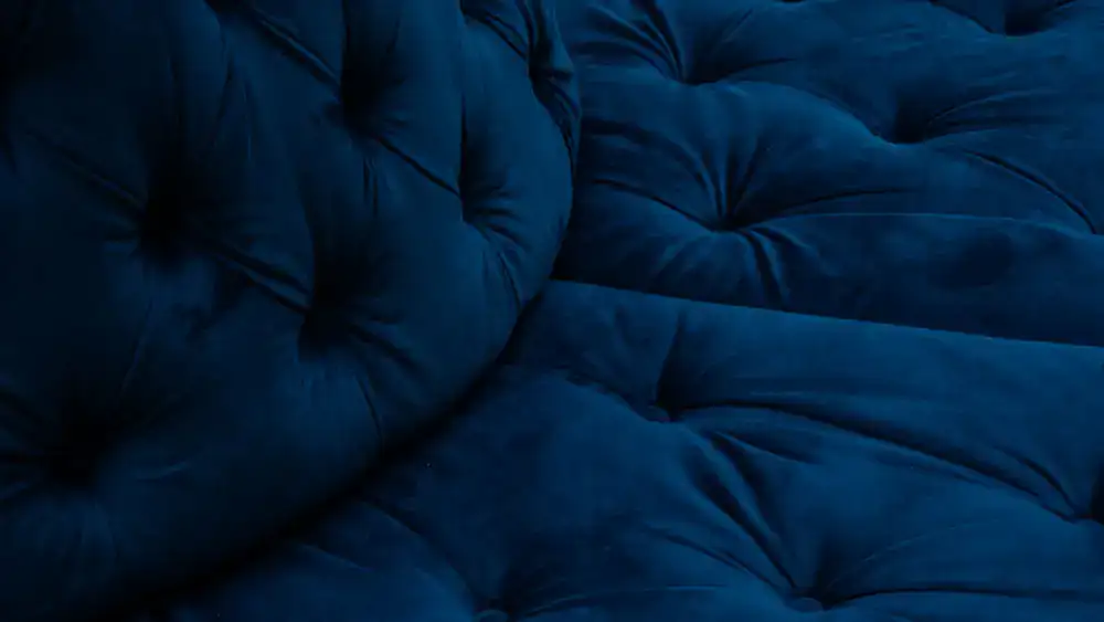 A fully restored vintage sofa in deep fabric