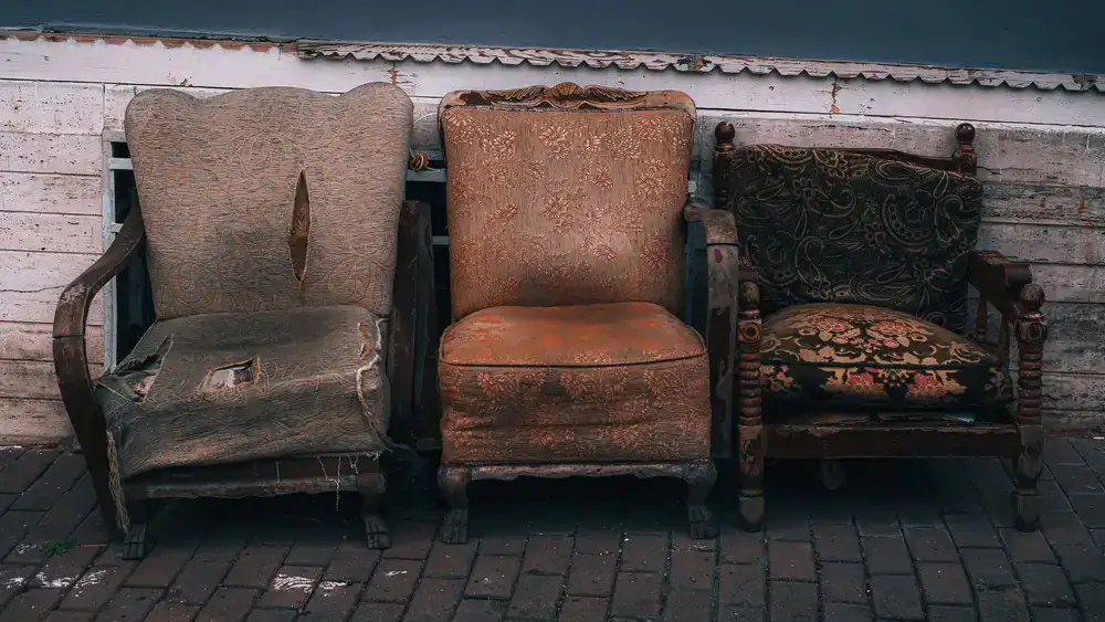 A side-by-side comparison of a worn chair and its fully restored final state