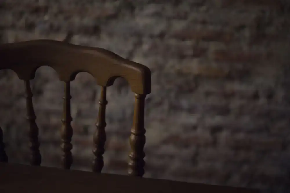 Antique chair being stuffed with traditional padding