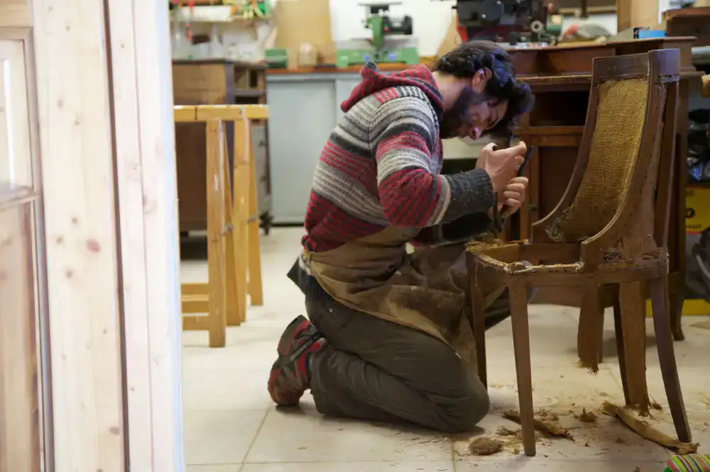 Restorer repairing a wooden chair frame